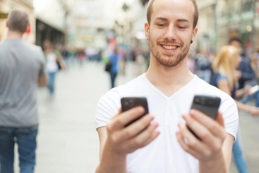 Create meme: a man with two phones, The guy with the smartphone, a person with two phones