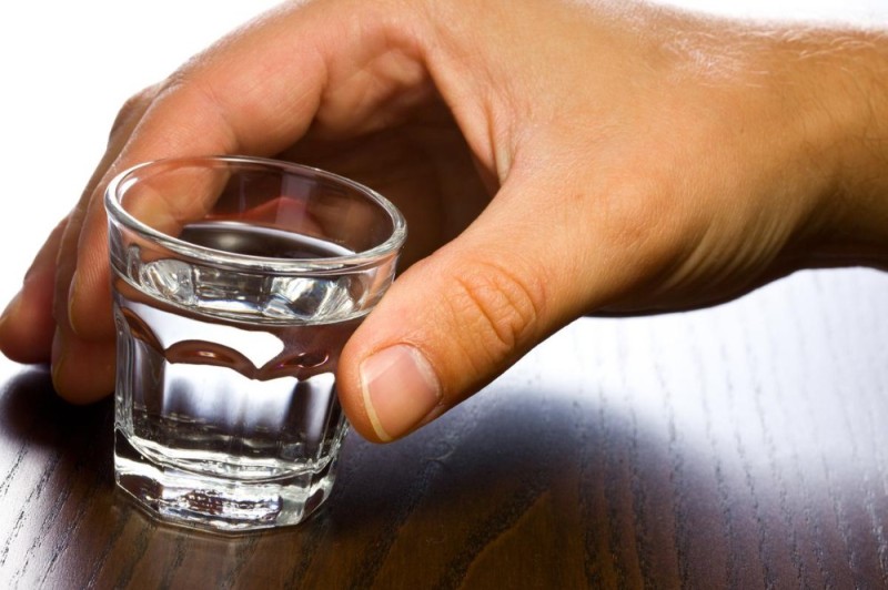 Create meme: a shot of vodka in your hand, a glass of vodka in your hand, hand with a glass