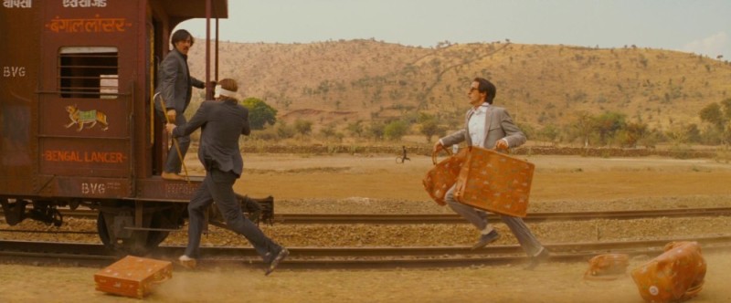 Create meme: suitcases in the movie Train to Darjeeling brand, jump into the last car, man runs after train