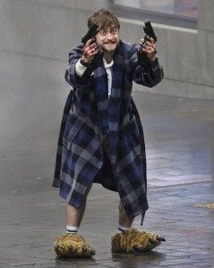 Create meme: Daniel Radcliffe with guns in a Bathrobe, guns akimbo, Daniel Radcliffe guns akimbo