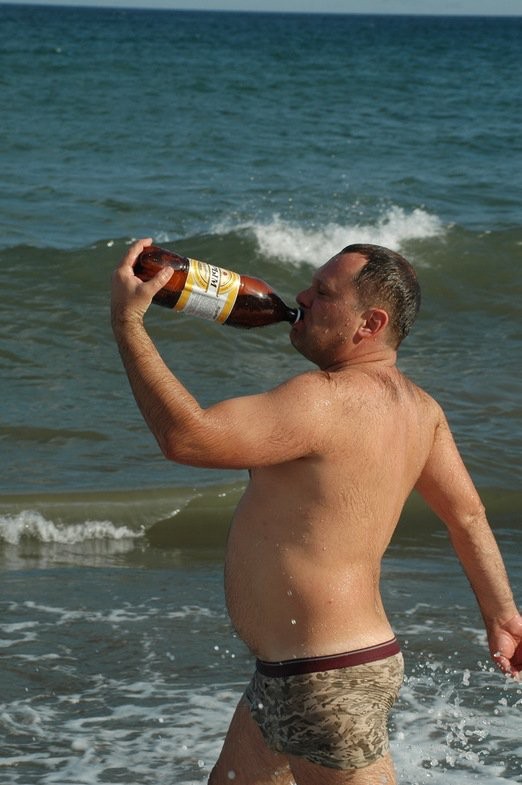 Create meme: Drunk on the beach, a man with a beer on the beach, Drunk at sea