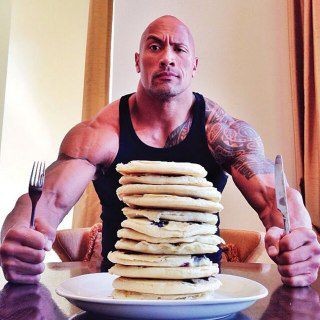 Create meme: The rock Dwayne Johnson eats pancakes, Dwayne the Rock Johnson with pancakes, Dwayne Johnson with pancakes