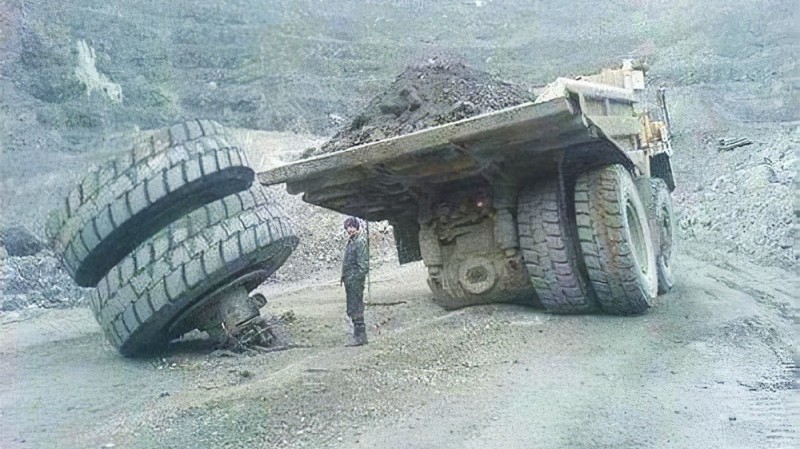 Create meme: belaz get the spare tire, belaz's wheel fell off, quarry dump truck flat tire