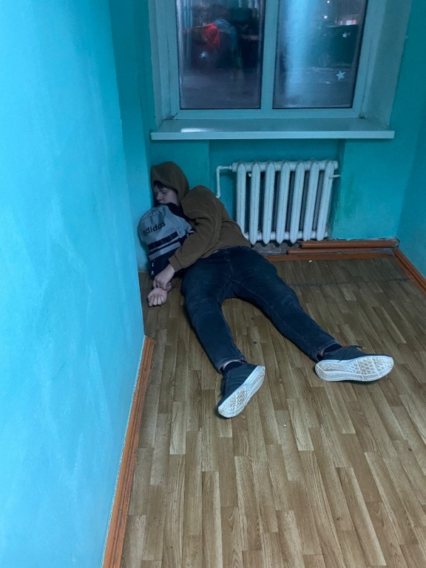 Create meme: addicts in the stairwell, feet , the guy is lying in the entrance