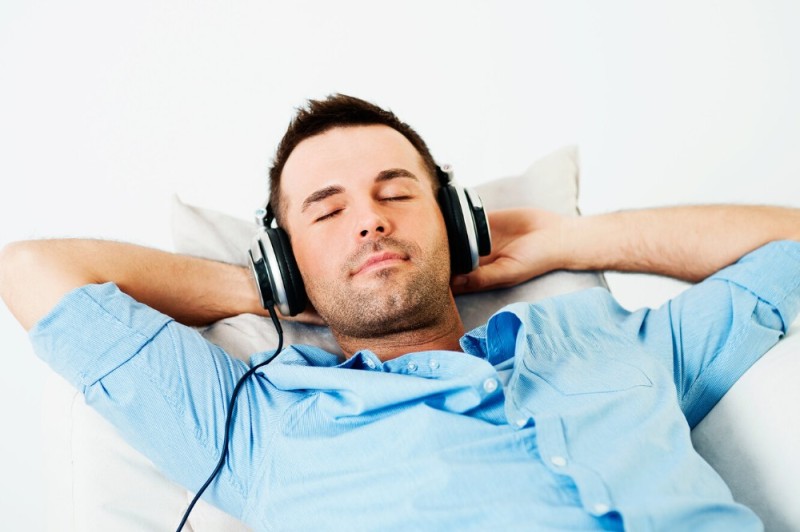 Create meme: a man with headphones, the man in the earphones, The man is lying with headphones on