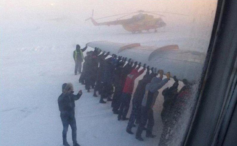 Create meme: plane at the airport, pushing a plane in Russia, passengers push the plane in igarka