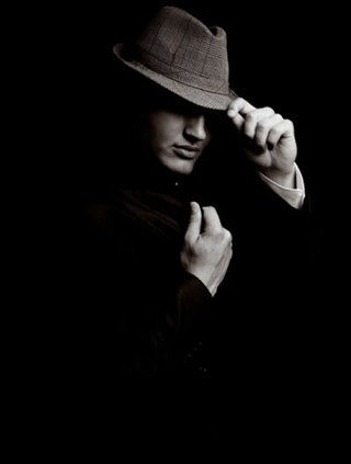 Create meme: a man in a hat on a black background, the man in the hat, mafia 