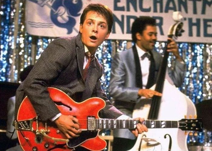 Create meme: michael J. Fox, Marty McFly with guitar, emma thompson tutti frutti