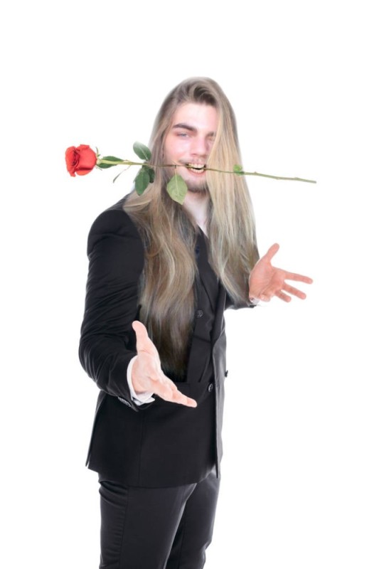 Create meme: a man with a rose in his mouth, with a rose in his teeth, the man with the roses