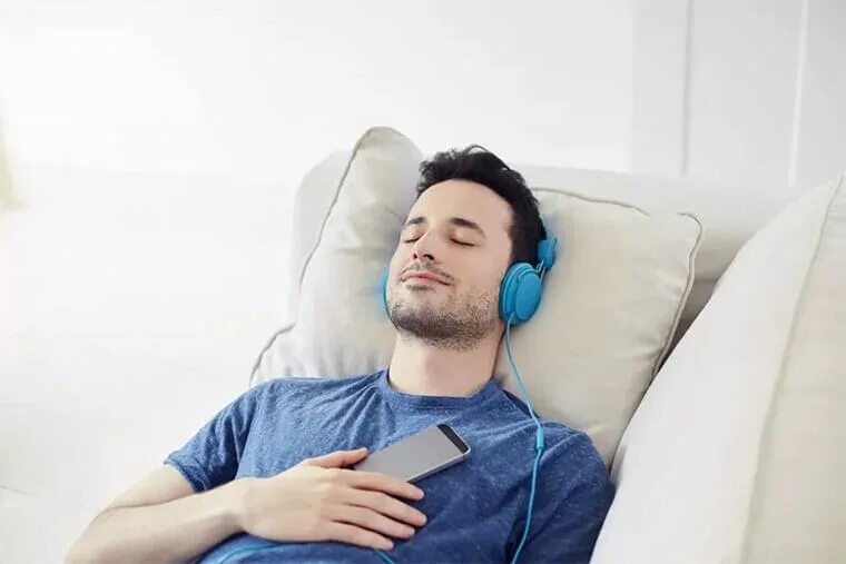 Create meme: The man is lying with headphones on, The man with the headphones, headphones