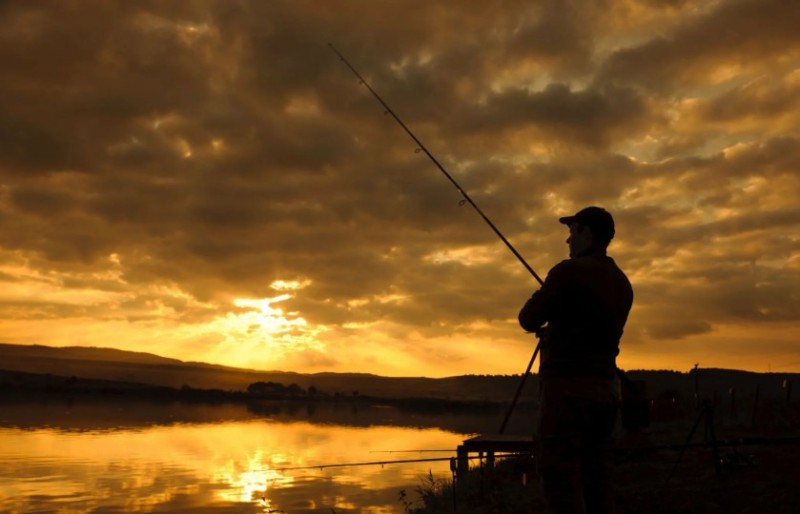 Create meme: fishing landscape, fisherman at sunset, fisherman with a spinning rod at sunset