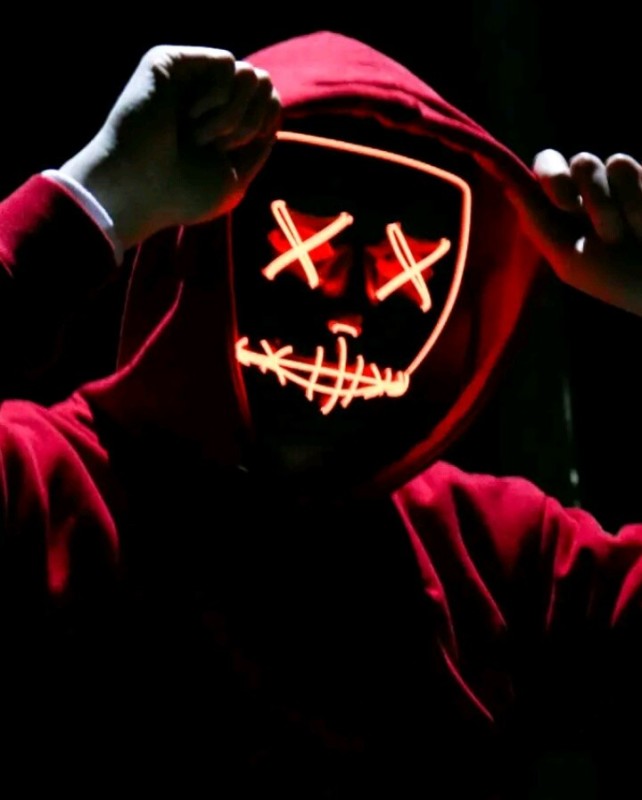 Создать мем: человек в маске с крестиками, хакер, светящаяся маска