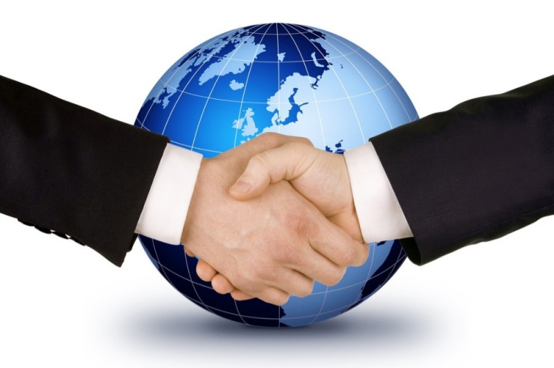 Create meme: international cooperation, handshake on the background of the globe, business handshake on the background of the earth
