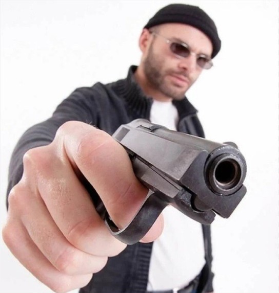 Create meme: gun to the camera, directional gun, a man with a gun