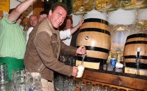 Create meme: Schwarzenegger beer, beer, the man next to barrels of beer