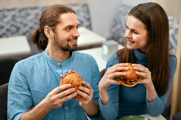 Создать мем: пара с едой, еда, парень и девушка с бургерами