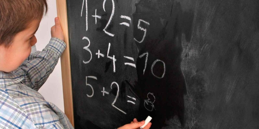 Create meme: the boy solves the examples at the blackboard, in school , math for kids