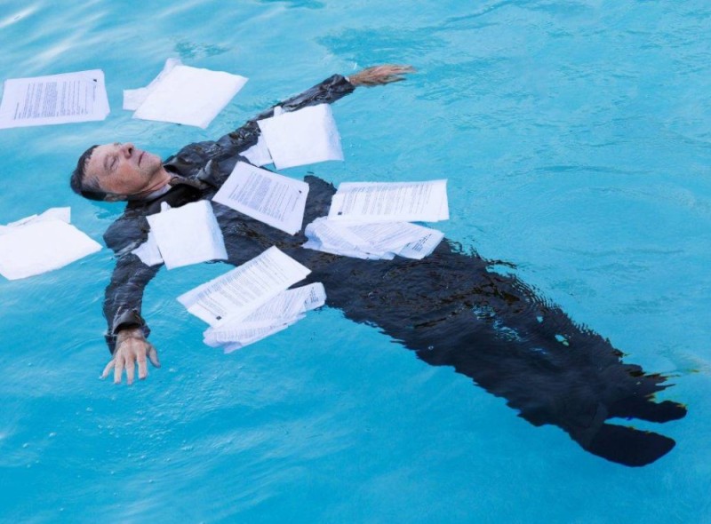 Create meme: a man in the water with papers, paper in water, drowning in water