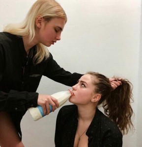 Create meme: drinking from the bottle, girl forcing milk girl, people