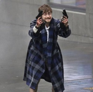 Create meme: Daniel Radcliffe guns akimbo, Radcliffe in a Bathrobe with a gun, Daniel Radcliffe in a Bathrobe