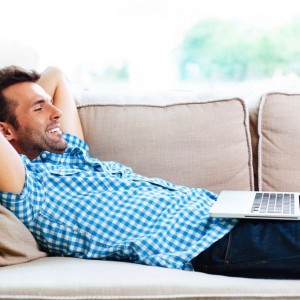 Create meme: male, man lying on sofa talking on phone, relaxed man addict photo