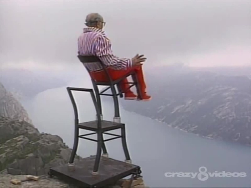 Create meme: on two chairs, a chair on a cliff, a man on two chairs