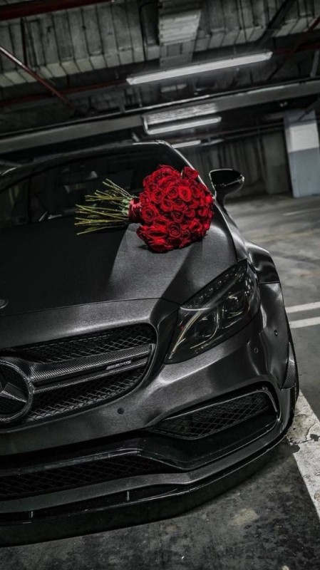 Create meme: mercedes black and red amg, black mercedes, flowers on the hood of the car