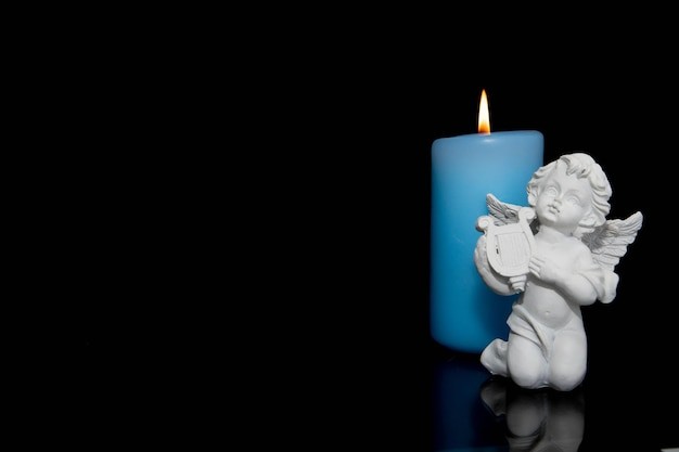Create meme: memory candle, candle on black background, angel with a candle
