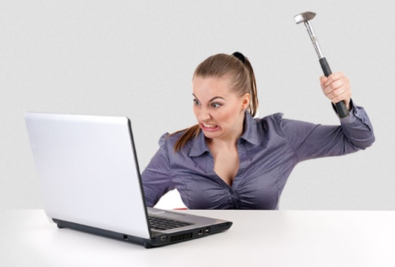 Create meme: angry woman at the computer, girl breaks laptop, angry girl with a laptop