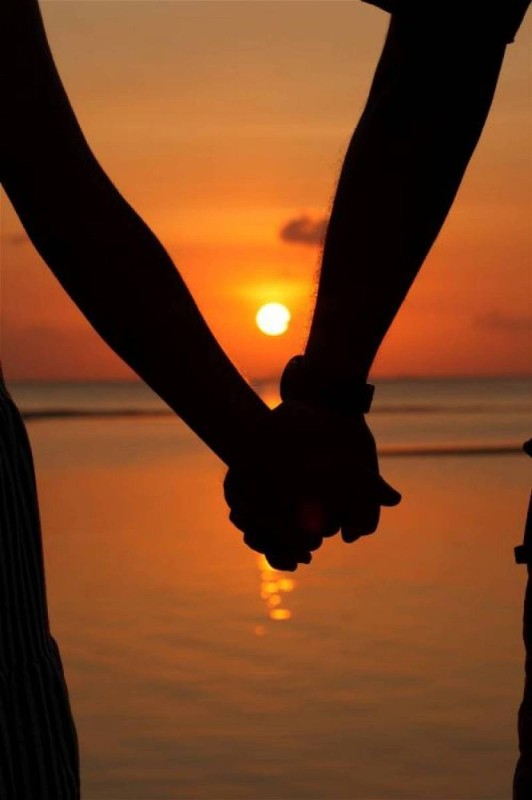 Create meme: body part, lovers' hands at sunset, holding hands at sunset
