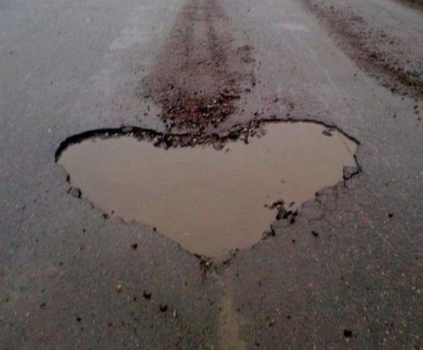 Create meme: Russian roads , pits on the road, about roads