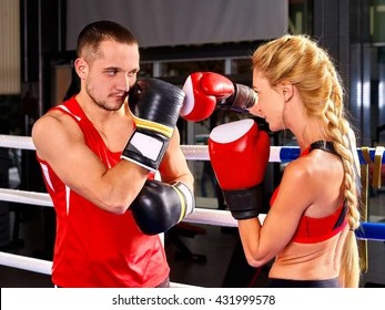Create meme: man and woman boxing, boxer and trainer in the ring, boxing girl