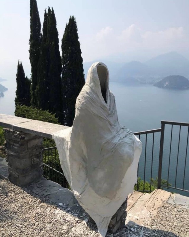 Create meme: sculpture of a ghost in the Vecio Castle, Lake Como, Italy., Lake Como ghost sculpture, Statue on Lake Como