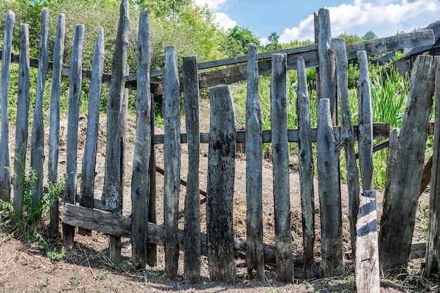 Create meme: old wooden fence, fence made of old boards, fence in the village