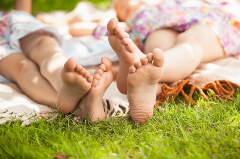 Create meme: children's feet in the grass, the child's legs on the grass, feet 