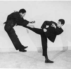 Create meme: Bruce Lee, bruce lee kick, kicking Jeet Kune do