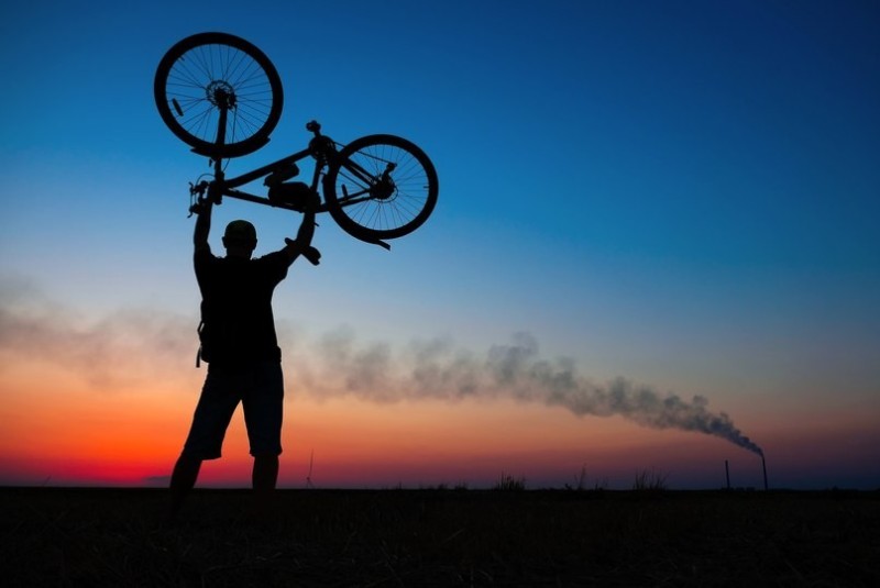 Create meme: a man with a bicycle head, bike , red sunset
