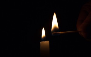 Create meme: photo of a candle on black background, a match in the dark, burning candle